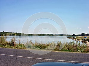 Rural pond on the Central Russian hill with a beach on the shore photo